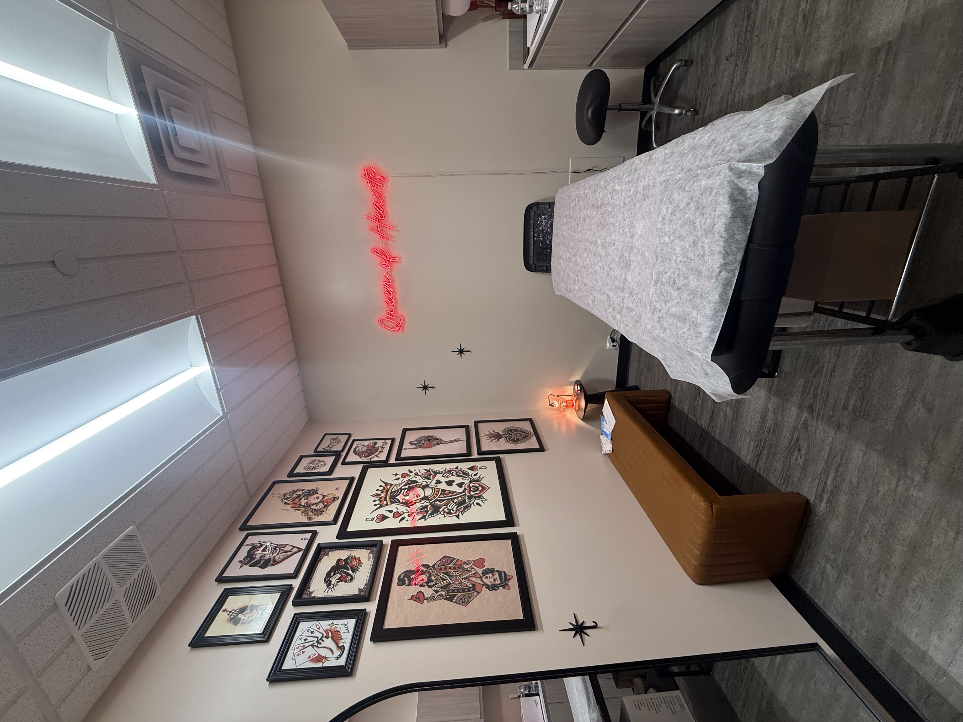 Queen of Hearts Wax Studio interior with neon sign
